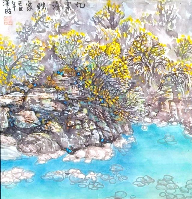 Yellow autumn trees above turquoise water